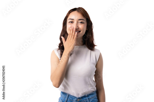 Slika na platnu Smiling Young Asian Woman Covering Mouth with Hand on Transparent Background