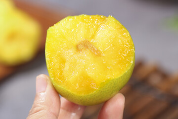 Fresh Yellow Lemon Half Close-Up Studio Photography with Hand Holding Juicy Citrus Fruit