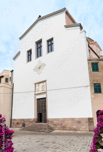 The facade of the Church of San Michele in the historic center of Alghero, Sardinia, Italy. Dedicated to Saint Michael the Archangel, the patron saint of the city