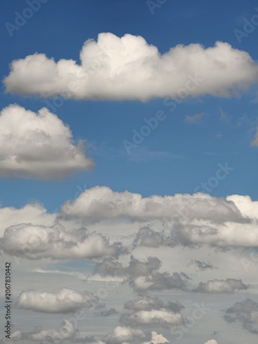 Fluffy White Cumulus Clouds Against Bright Blue Sky