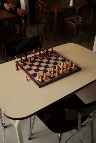 A High Angle View of a Chess Set on a Table in a Quiet Cafe or Restaurant Setting