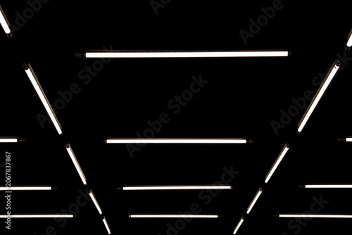 Modern geometric pattern LED linear lights installation on a black ceiling