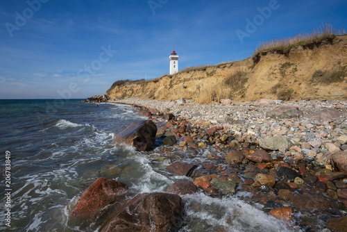 Scenic Baltic Sea coastline with cliffs and Helnaes Fyr lighthouse on Funen island, a perfect sea trout fishing hot spot