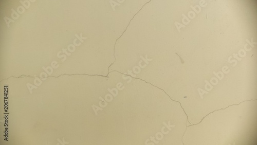 Schilderij op canvas Fissured Exterior Coating showing fine hairline splits on a light beige facade