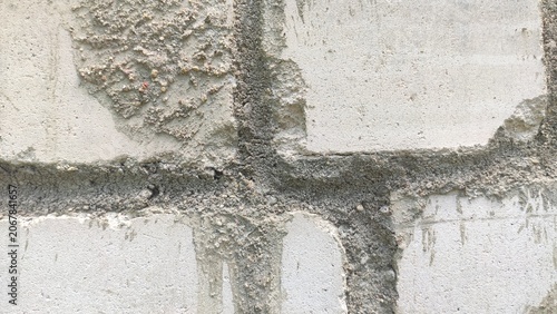 Thick Concrete Joints separating white rectangular building blocks in a rough facade. For construction engineering materials, minimalist masonry backgrounds, and architectural renders.
