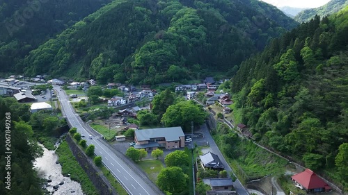 Aerial drone footage of Yuki Onsen hot spring village surrounded by mountains in Hiroshima