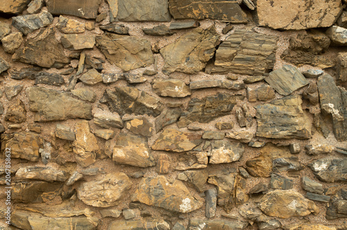 Old Yellow and brown stone wall closeup