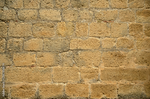 Old stone wall from yellow sandstone closeup