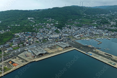 Aerial drone photo of Tateura fishing port and coastal town in Ikitsuki, Hirado, Nagasaki, Japan