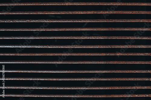 Rusty horizontal metal slats forming an abstract industrial background