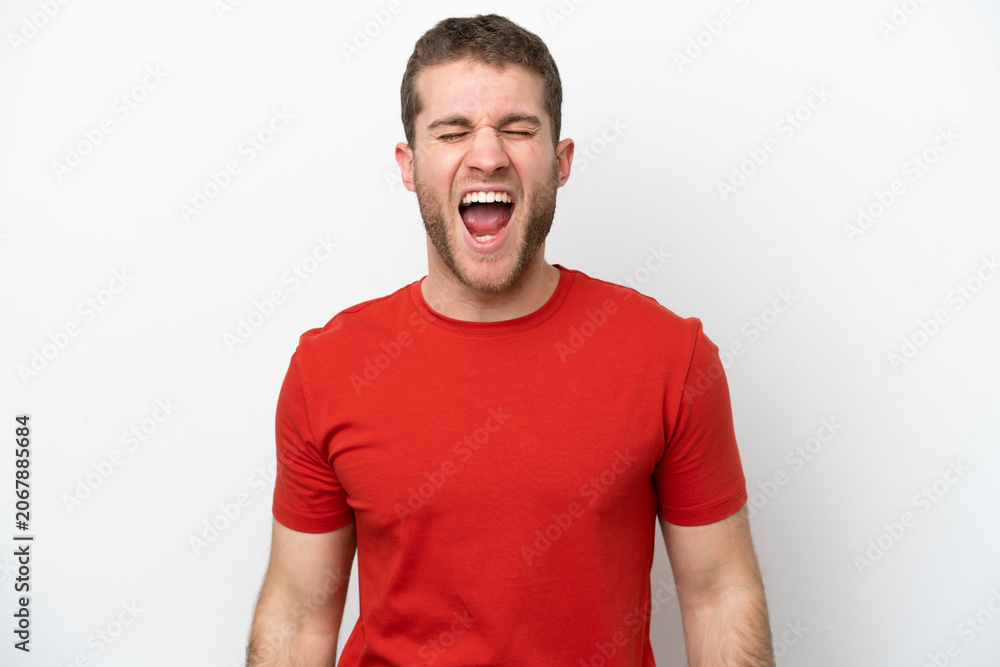 Obraz premium Young caucasian man isolated on white background shouting to the front with mouth wide open