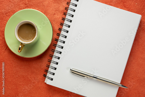 blank spiral notebook, flat lay with coffee on textured art paper
