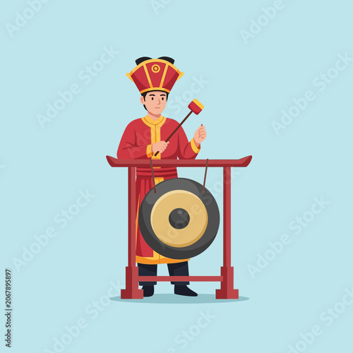 Man in traditional attire playing a gong with a mallet