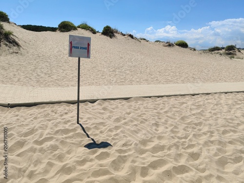 Free Zone Sign Post on a Sandy Beach.