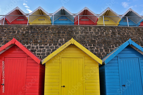 Colourful Whitby Beach Huts at Whitby Seafront, North Yorkshire; vibrant wooden seafront boxes, traditional British seaside architecture, summer travel, England, UK