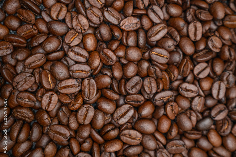 Fototapeta premium Horizontal full frame texture background of premium roasted coffee beans.