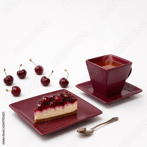 Cherry cheesecake served with hot coffee on white background, breakfast dessert concept.