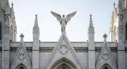 Guardian stone angel statue on a Gothic cathedral roof facade