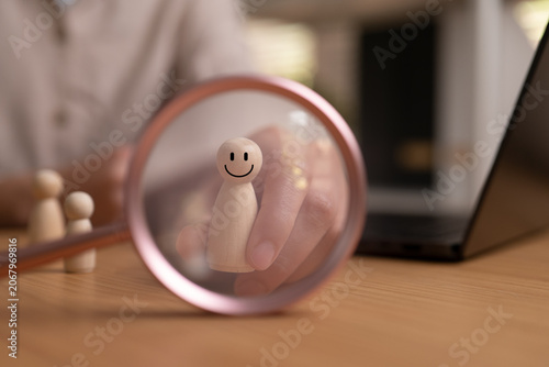 Fotografie Conceptual image of self care and positive mindset with a smiling wooden figure