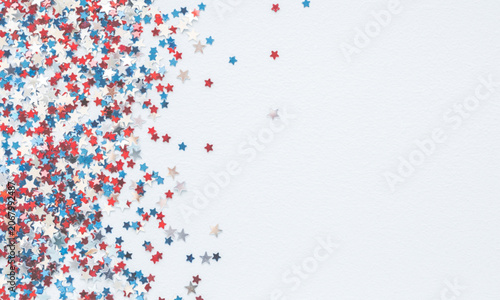 Foto Colorful star confetti scattered on white background for celebration