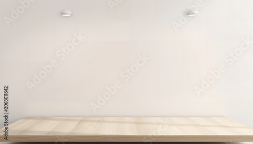 A light-colored wooden table against a plain white wall with two small white objects mounted on the wall above it