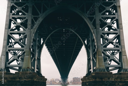 фотографія Close-up of large bridge structure with metal beams and arches