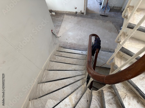 Interior staircase under renovation with protective coverings