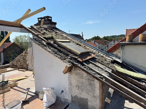 Rooftop under construction with exposed beams and insulation