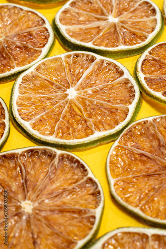 Macro: dried lemon slices on a yellow background
