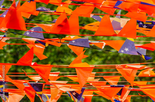 Rotterdam, The Netherlands, May 31, 2026: multitude of orange banners in realtion to the football world cup, with also some flags of Curcacao added