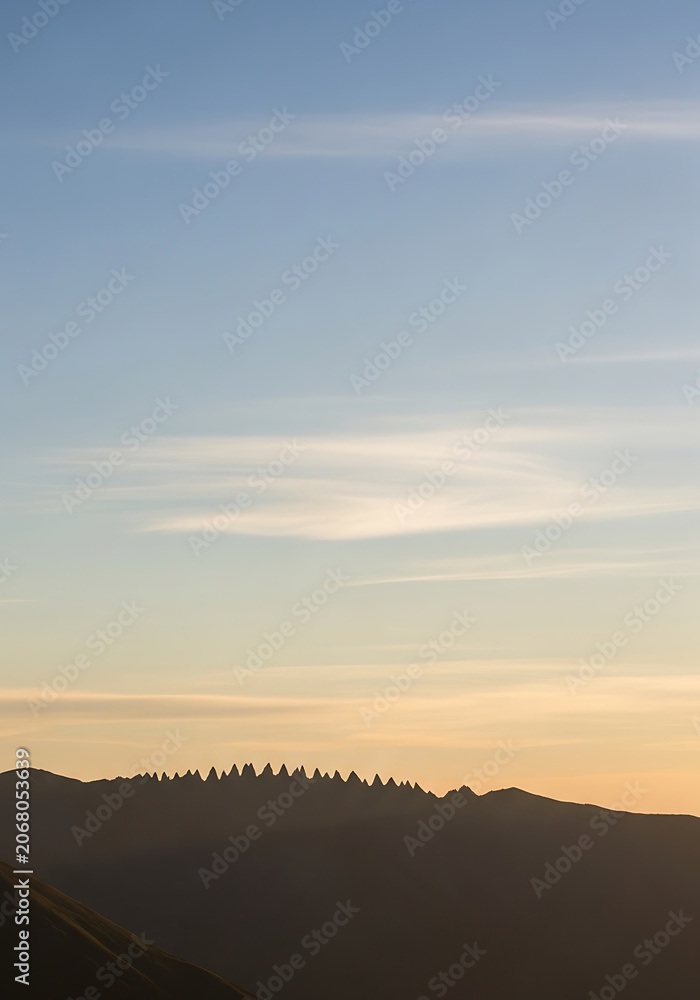 Obraz premium Golden hour over calm rural landscape with wind turbines.