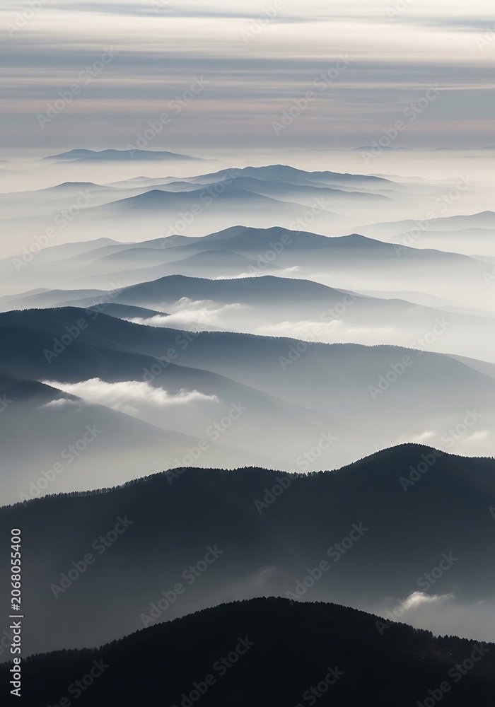 Fototapeta premium Dramatic aerial view of snow capped mountain peaks.