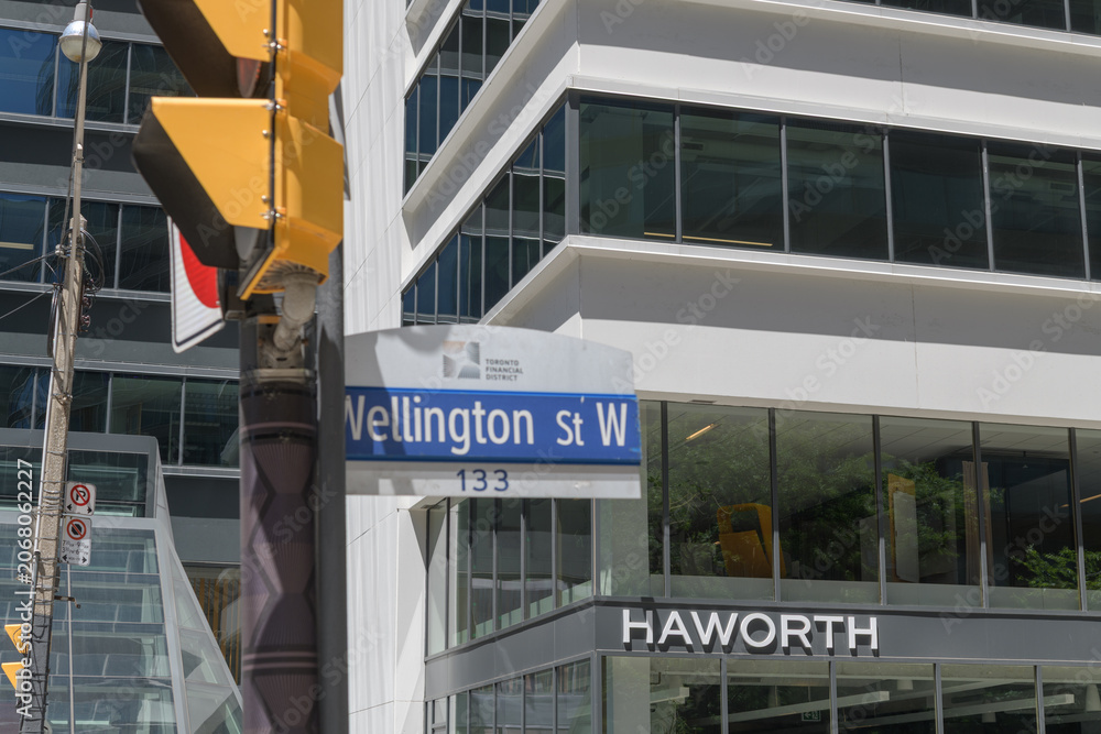 Naklejka premium exterior building facade and sign of Haworth, an office furniture store, and defocused street sign, at 55 University Av, Toronto