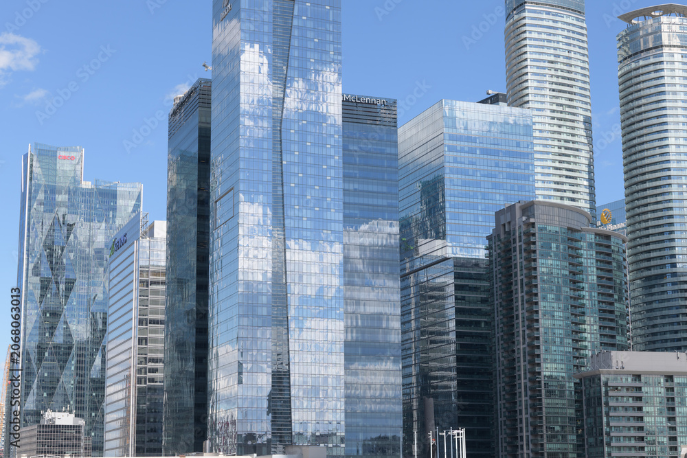 Naklejka premium reflection of a cloudy blue sky on high-rises in the South Core / South Financial District, Toronto