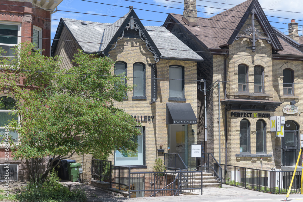 Naklejka premium exterior of Bau-Xi Gallery and PERFECT X HAIR - Art Gallery, historic houses opposite the Art Gallery of Ontario, Dundas St W, Toronto