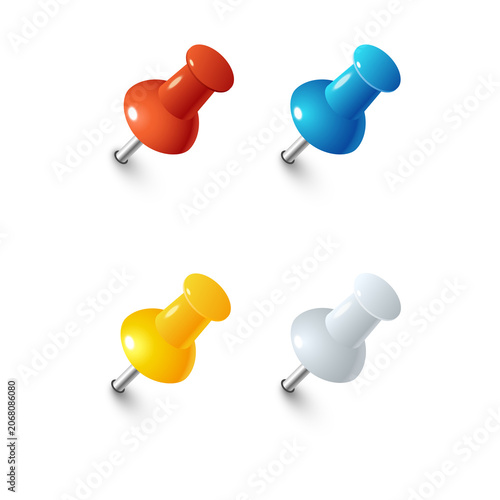 Set of four colorful plastic push pins in red, blue, yellow, and silver colors with metallic sharp points isolated on a transparent background