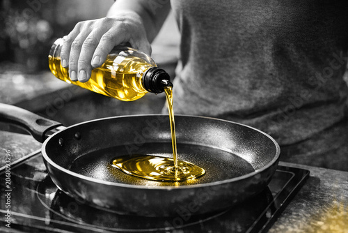 Person preparing food at kitchen stove.