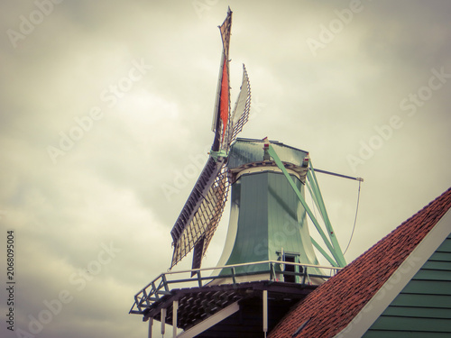 The windmill “De Huisman” (The Huisman). Traditional Dutch old wooden windmill in Zaanse Schans - museum village in Zaandam. The Netherlands.