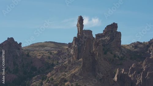 Aerial view of God's Finger geological rock formation, set against a clear blue sky in Valle Encantado, Patagonia, Argentina.