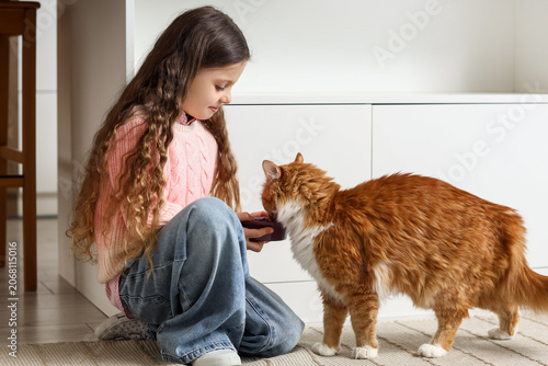 Cute little girl feeding fl...