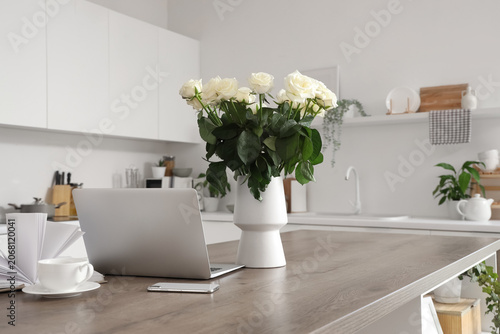 Vase with white roses, gadg...