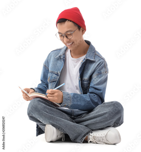 Young Asian man with notebo...