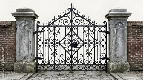 Ornate wrought iron gate with stone pillars