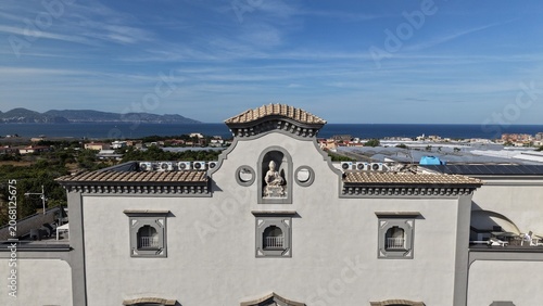 Quadro em tela Aerial drone view of white historic church facade with bell tower and decorative