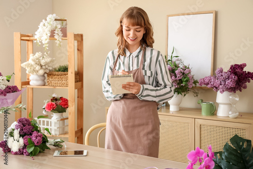 Female florist with noteboo...