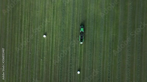 Tractor collects hay on his farm