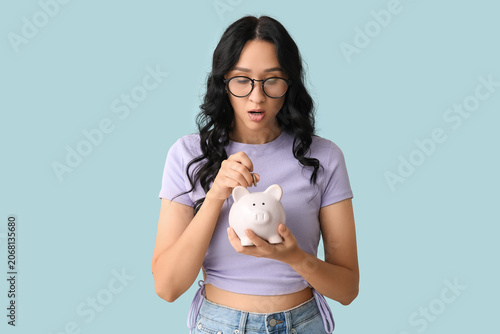 Shocked young woman putting...