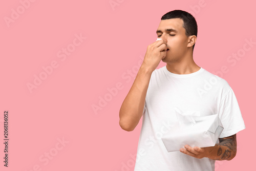 Ill young man with tissues ...