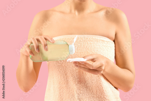 Young woman pouring micella...