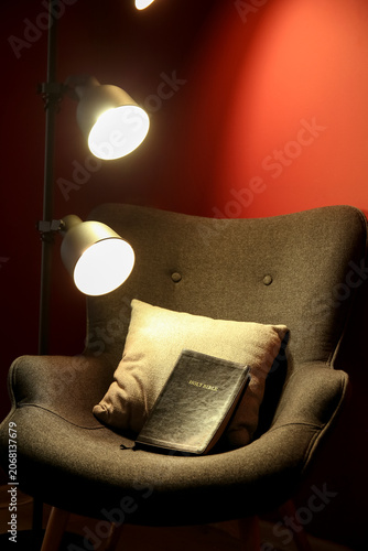 Holy Bible in armchair with...